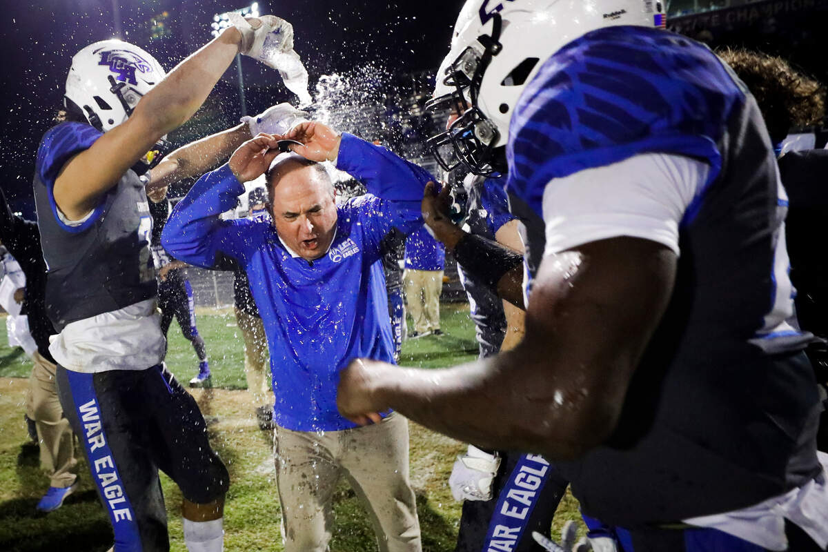 Lexington Christian’s head coach Doug Charles is drenched with water after the Class 2A 2020 UK Orthopaedics state football semifinals against Murray at Lexington Christian Academy in Lexington, Ky., Friday, Dec. 11, 2020. Lexington Christian beat Murray 48-13.