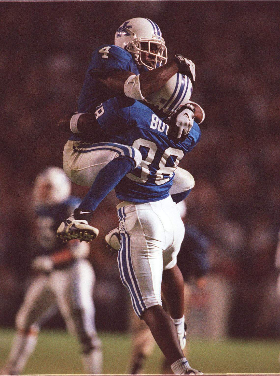 UK’s Littleton Ward (4) and Jeremy Bowie (38) celebrated after Bowie recovered an Alabama fumble in overtime.
