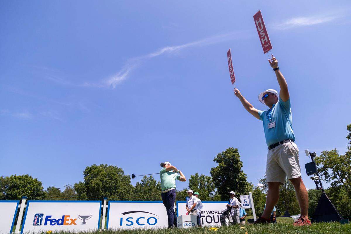 A volunteer holds up quiet signs as Lukas Nemecz hits a tee shot during the third round of the 2024 ISCO Championship. This year’s tournament, formerly known as the PGA Barbasol, featured the lowest 36-hole cut in an individual, stroke-play event in PGA Tour history.