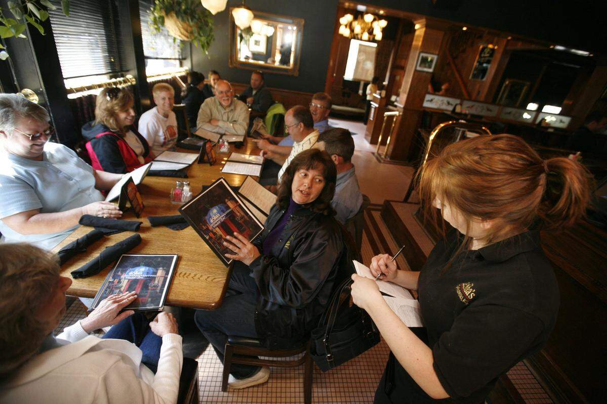 A table of bus drivers who drove teams and fans to the a Sweet 16 basketball tournament gathered at DeSha’s restaurant in 2009. The restaurant was popular being across the street from Rupp Arena.