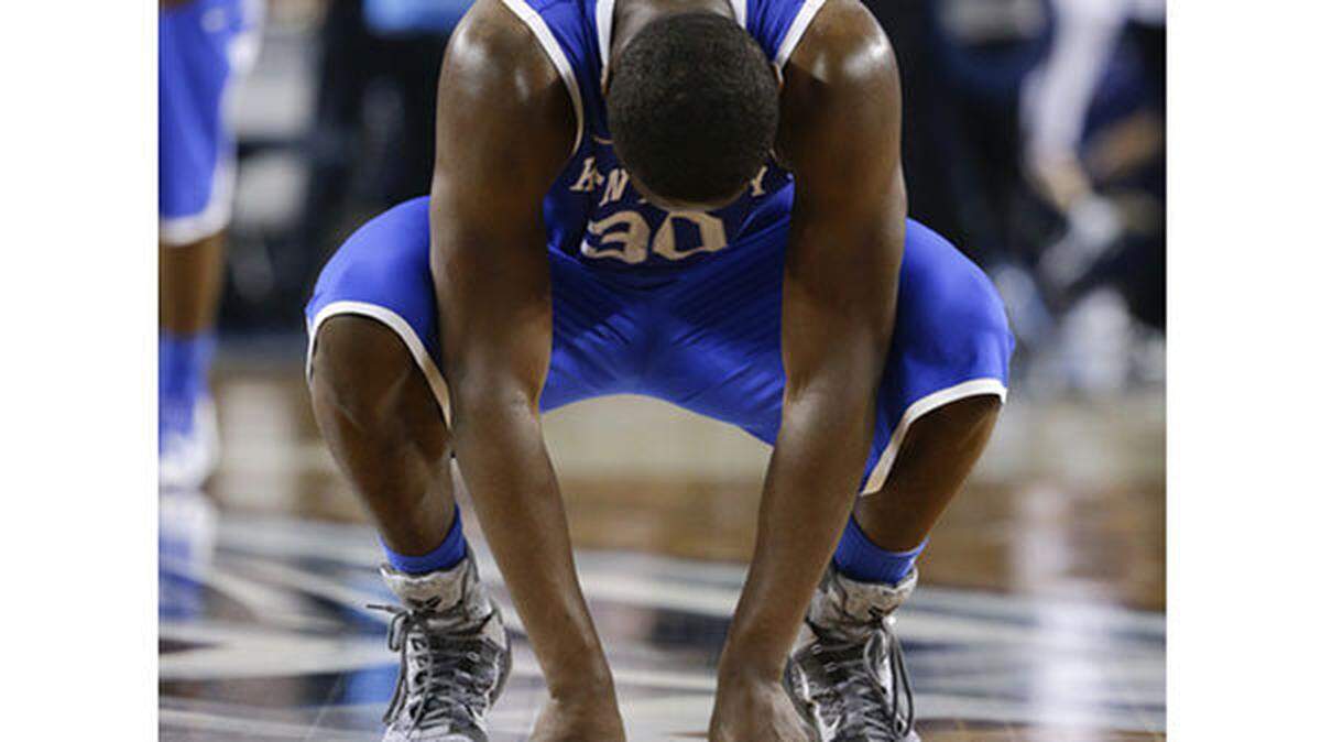 Kentucky Wildcats forward Julius Randle (30) hung his head as he collapsed to the floor as Connecticut defeated Kentucky  for the national championship on Monday April 7, 2014 in  Arlington, TX.