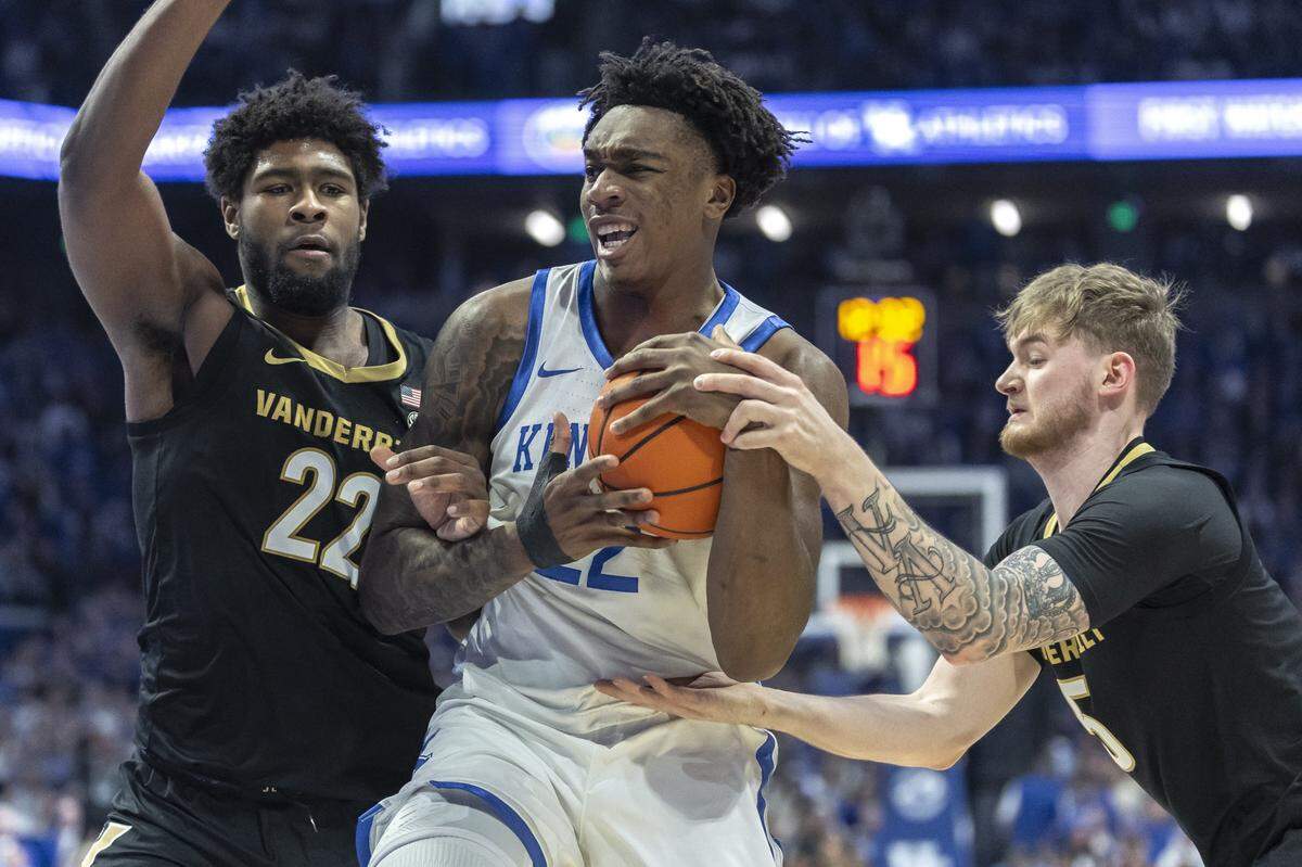Kentucky center Amari Williams (22) drives the ball as Vanderbilt forward Jaylen Carey (22) and guard Tyler Nickel (5) defend during Wednesday’s game at Rupp Arena.