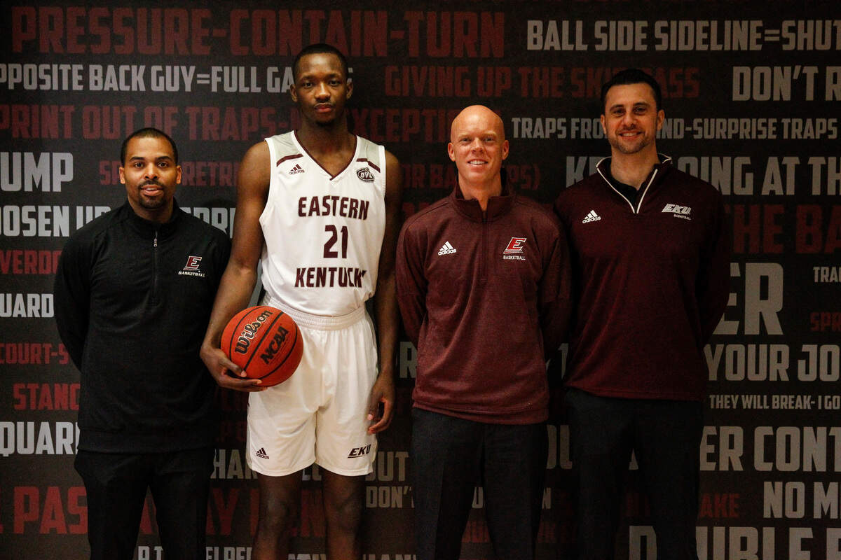 After signing with EKU, Tariq Balogun was pictured with, from left, assistant coach Mike Allen, head coach A.W. Hamilton and assistant coach Steve Lepore.