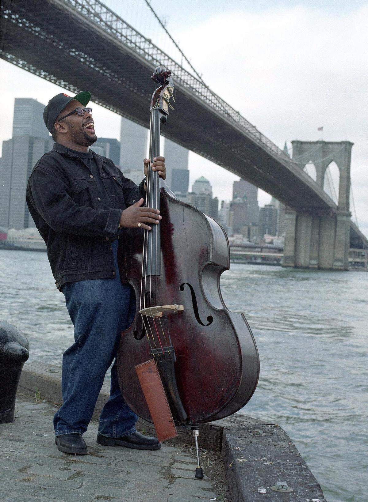 Jazz musician Christian McBride plays his double bass under the Brooklyn Bridge on the Brooklyn side of New York’s East River.