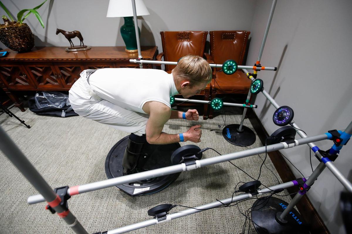 James Graham demonstrates a new concussion testing methods researchers with UK have been working on with jockeys at Keeneland, designed to be more comfortable and natural for jockeys at Keeneland in Lexington, Ky., Friday, October 28, 2022.