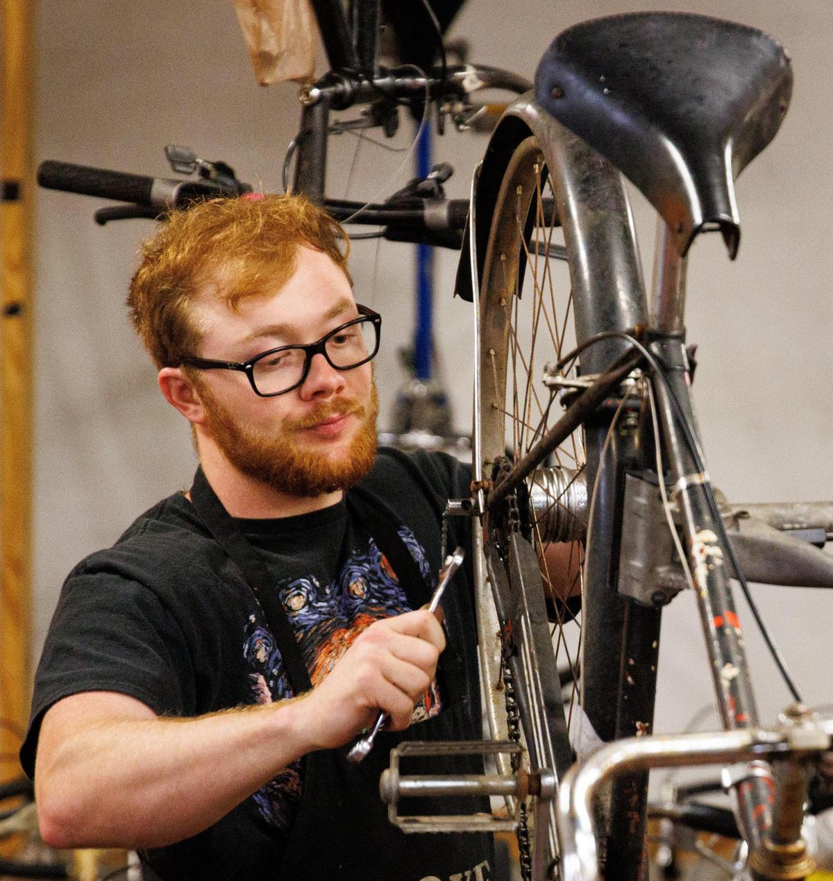 A person works on their bicycle on Sunday, May 22, 2022, at Broke Spoke Community Bike Shop in Lexington, Kentucky.