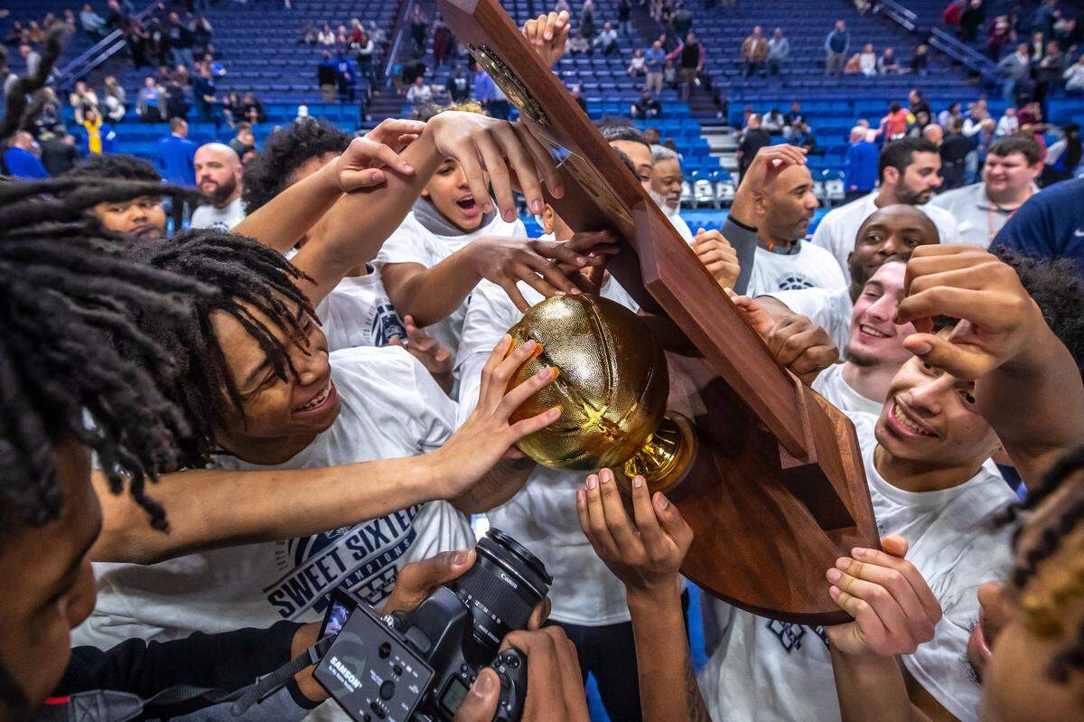 Warren Central players celebrate with the trophy after winning Kentucky’s 2023 boys’ high school basketball state championship in Rupp Arena on Saturday night.