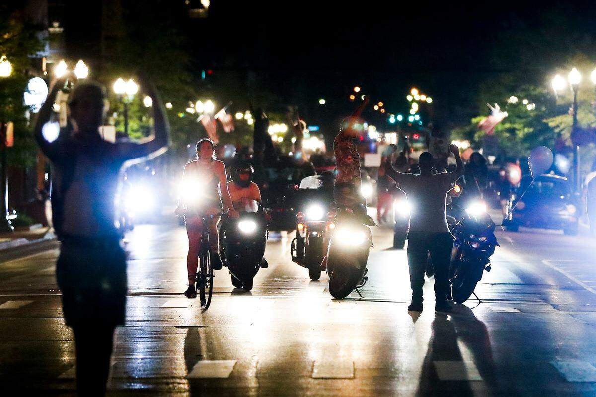 Demonstrators, some on motorcycles, gather along East Main Street during the 12th night of protests in Lexington on Tuesday.