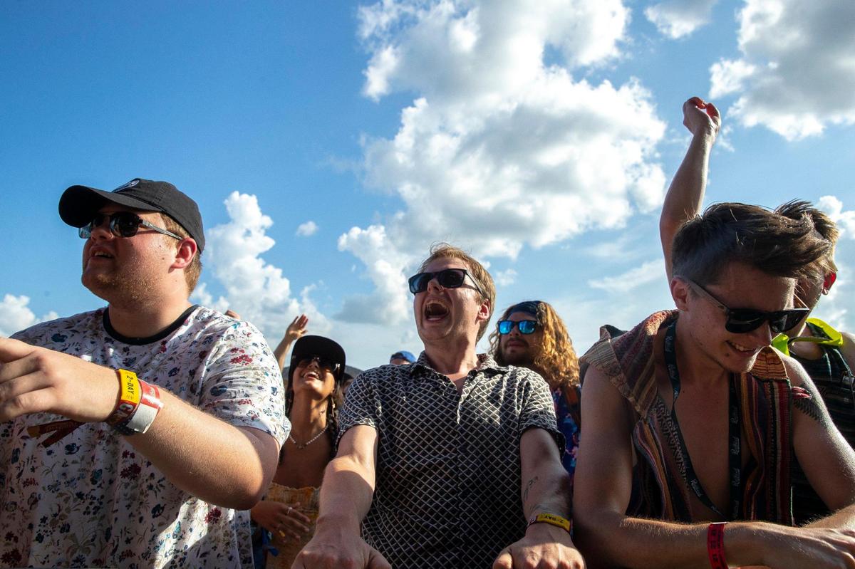 Festival goers listen as the Black Pumas perform at the Railbird Festival at Keeneland in Lexington, Ky., on Saturday, Aug. 28, 2021.
