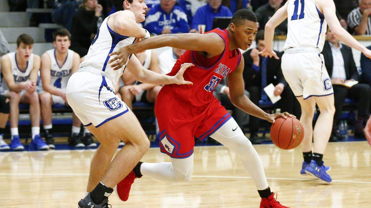 Madison Central’s Isaiah Cozart (50) dribbled past Covington Catholic’s Neil Green (33) during their game Friday at Covington Catholic High School in Covington, Ky. Covington Catholic beat Madison Central 57-45.