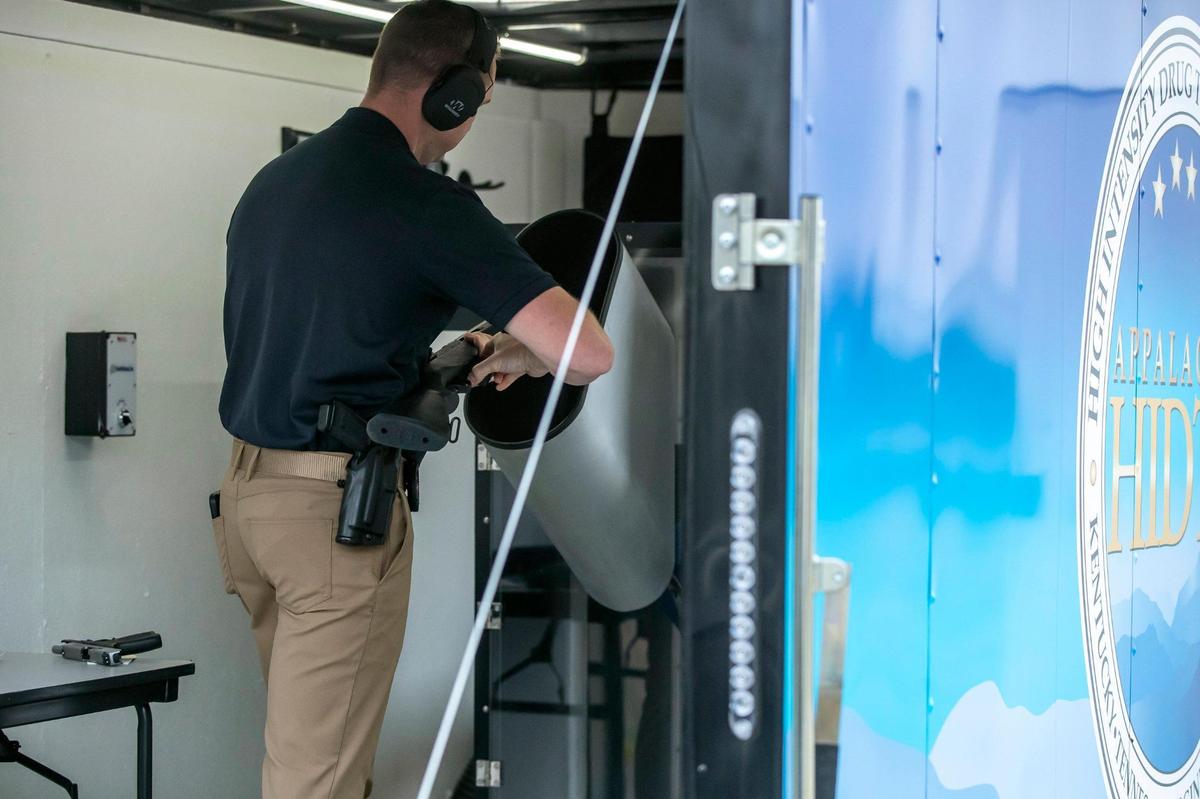 Somerset Police Department Capt. Shawn Dobbs prepares to fire a gun so the casings can be collected for imaging by the Appalachia High Intensity Drug Trafficking Area task force in London, Ky., on Wednesday, April 5, 2023.