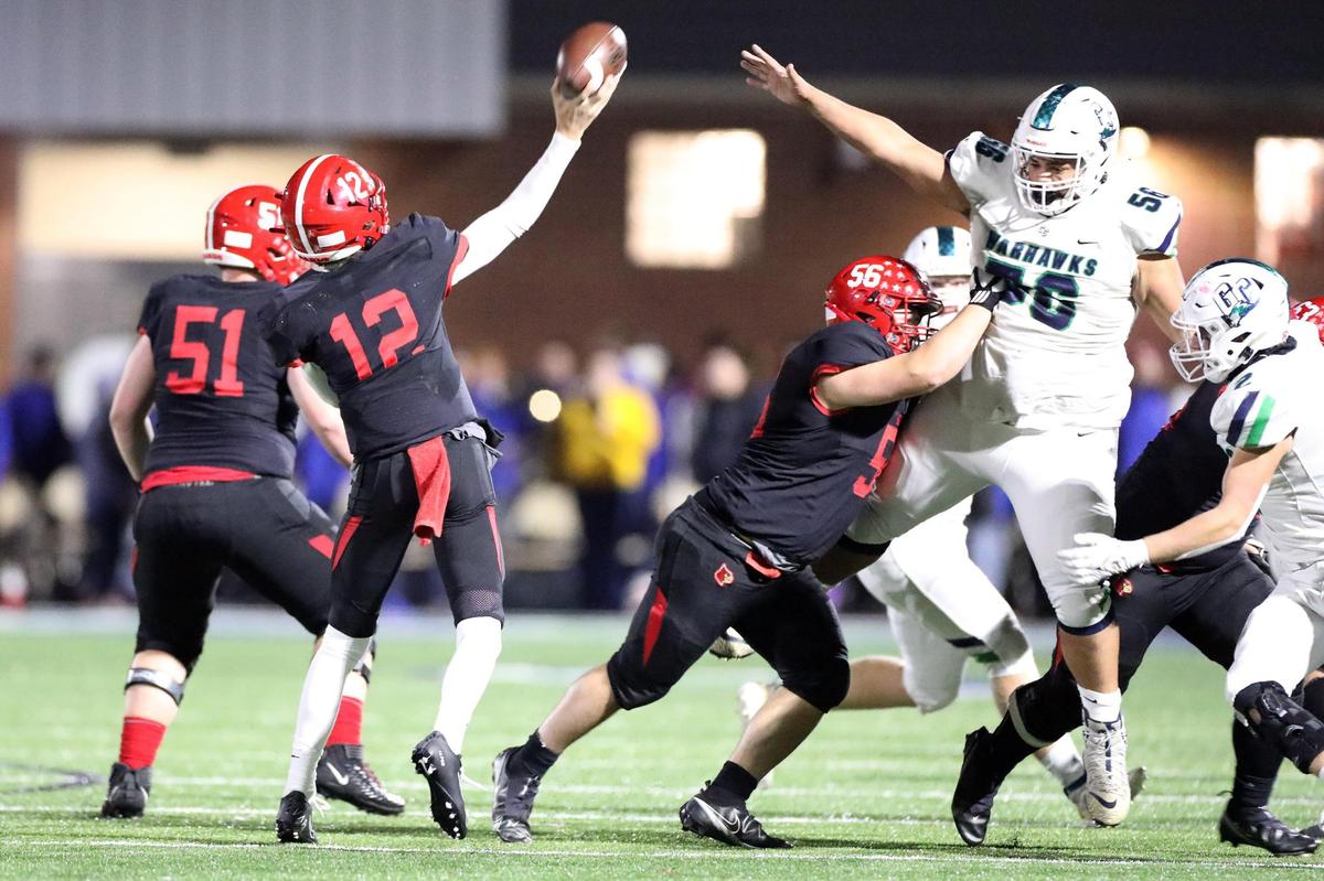 Great Crossing’s Tre Combs (56) leaps to try and block what would be a first half touchdown throw by Scott County’s Andrew Hickey (12) during a Friday high school football playoff game between the Great Crossing Warhawks and the Scott Co. Cardinals.