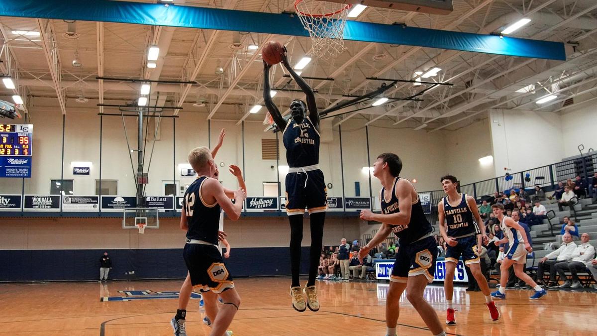 Danville Christian’s Leek Ateny (15) grabbed a rebound amid teammates as the Warriors faced Lexington Catholic in Lexington on Feb. 18.
