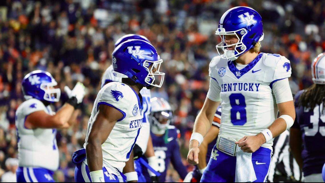 Kentucky wide receiver Kendrick Law (1) celebrates a touchdown catch with quarterback Cutter Boley (8) during Saturday’s game against Auburn.