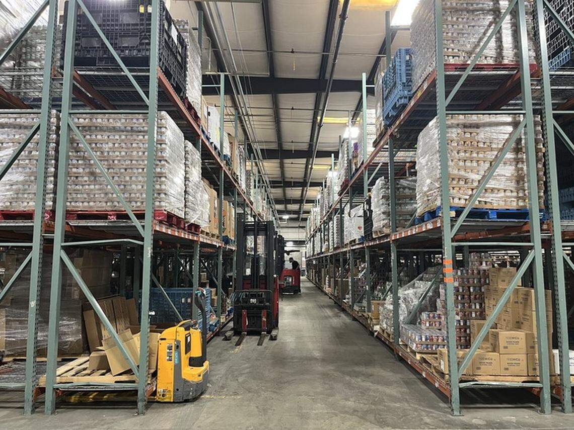 An individual sorts through donations at Dare to Care Food Bank in Louisville Tuesday, Nov. 4, 2025.
