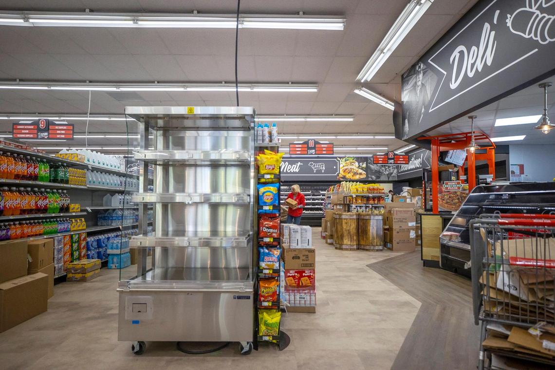 Two days before the store’s re-opening, employees work to fill shelves at the Isom IGA.