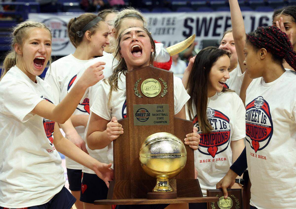 Sacred Heart team members celebrate after defeating Bullitt East for the championship game of the Mingua Beef Jerkey Girls’ Sweet 16 at Rupp Arena in Lexington, Ky., Saturday, March 12, 2022. (Photo by James Crisp)