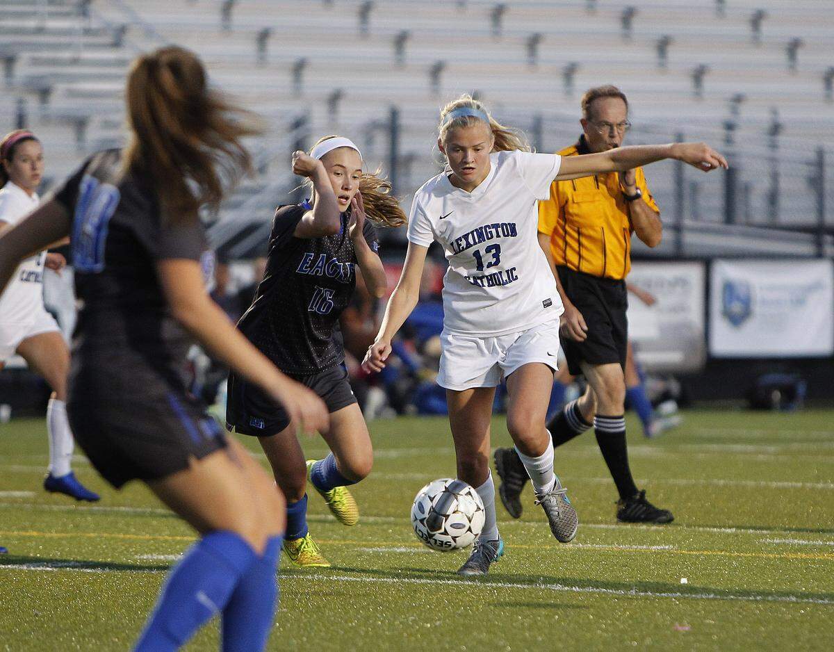 Lexington Catholic wants the ball on Maggie Corbett’s (13) foot as much as possible while Lexington Christian depends on Grace Jacobs (16) to anchor its defensive back line.