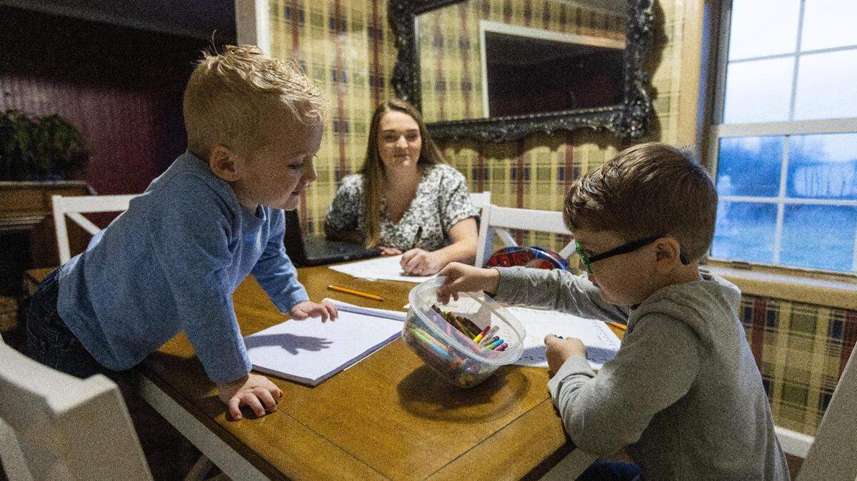 Judge executive candidate Heather Baldwin, center, assists two of her children Henry, left, and Spencer, right, with their homework as they work at their kitchen table. She is running for judge-executive as a Democrat in Lincoln County.