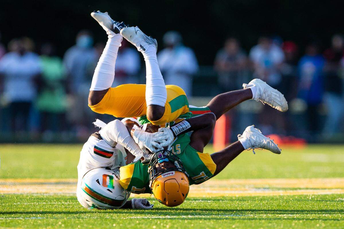 Bryan Station wide receiver Tylin Israel (11) is tackled by Frederick Douglass’s Steve Lawson (55) during Friday’s game.