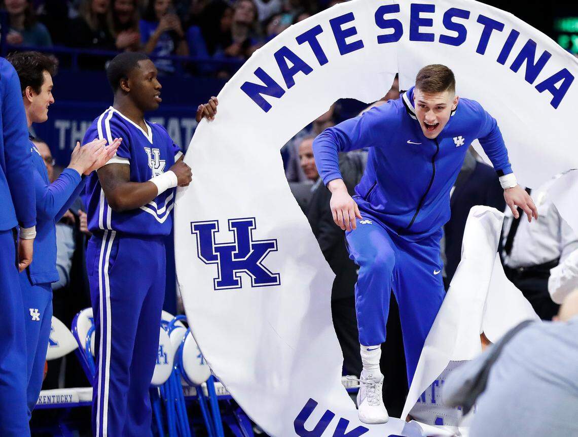 Kentucky forward Nate Sestina (1) broke through UK’s traditional Senior Day paper hoop before the Wildcats’ 81-73, come-from-ahead loss to Tennessee in Rupp Arena.