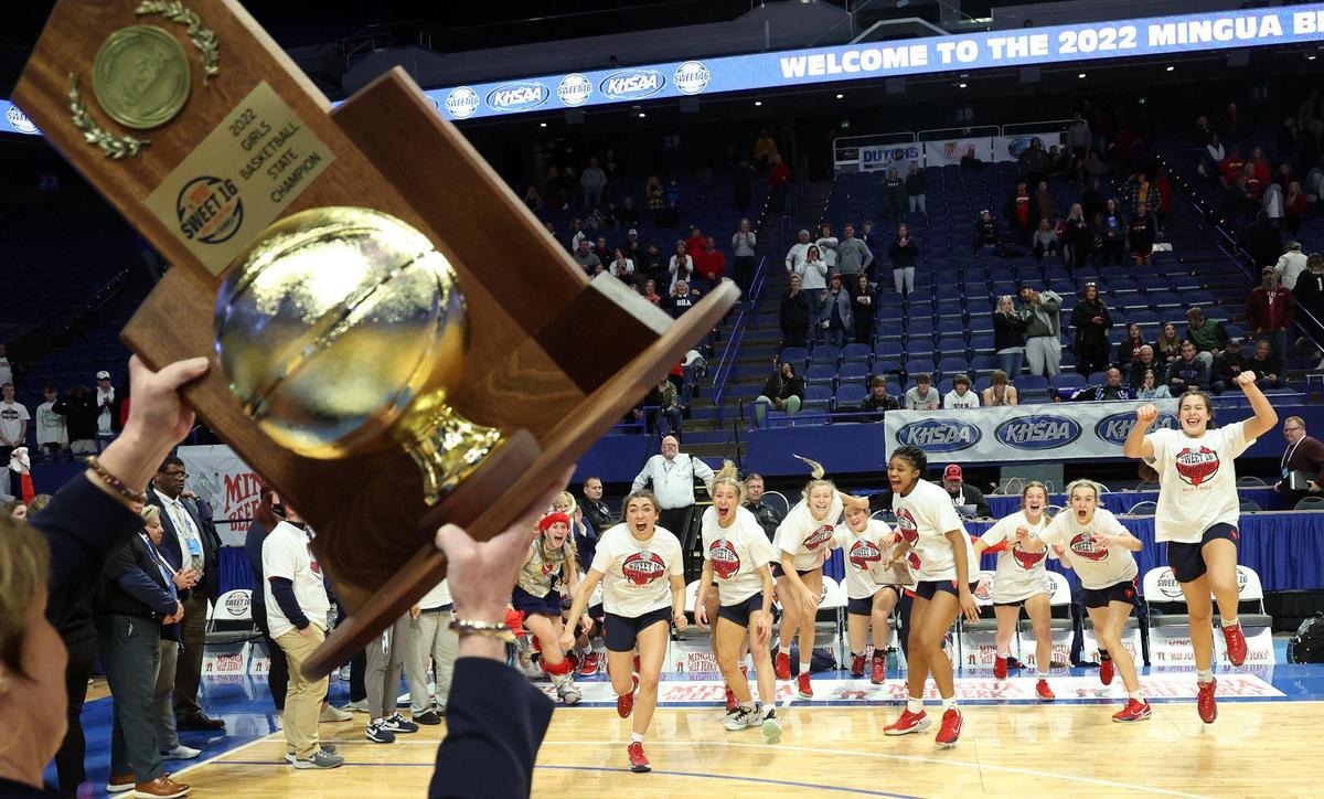 Sacred Heart’s players react as they are invited to receive the state championship trophy after defeating Bullitt East on Saturday night in Rupp Arena.