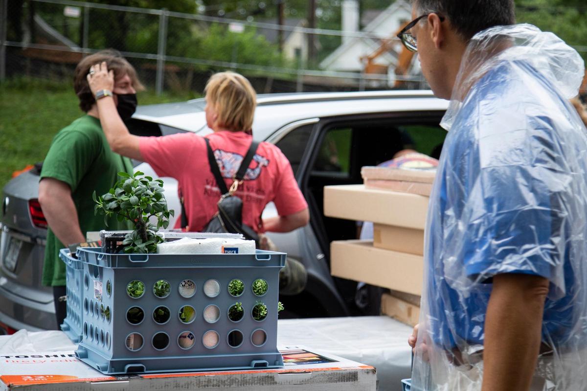 Plants and other belongings sits on a cart ready to be taken into a student’s dorm at Woodland Glen III on the UK campus Monday.