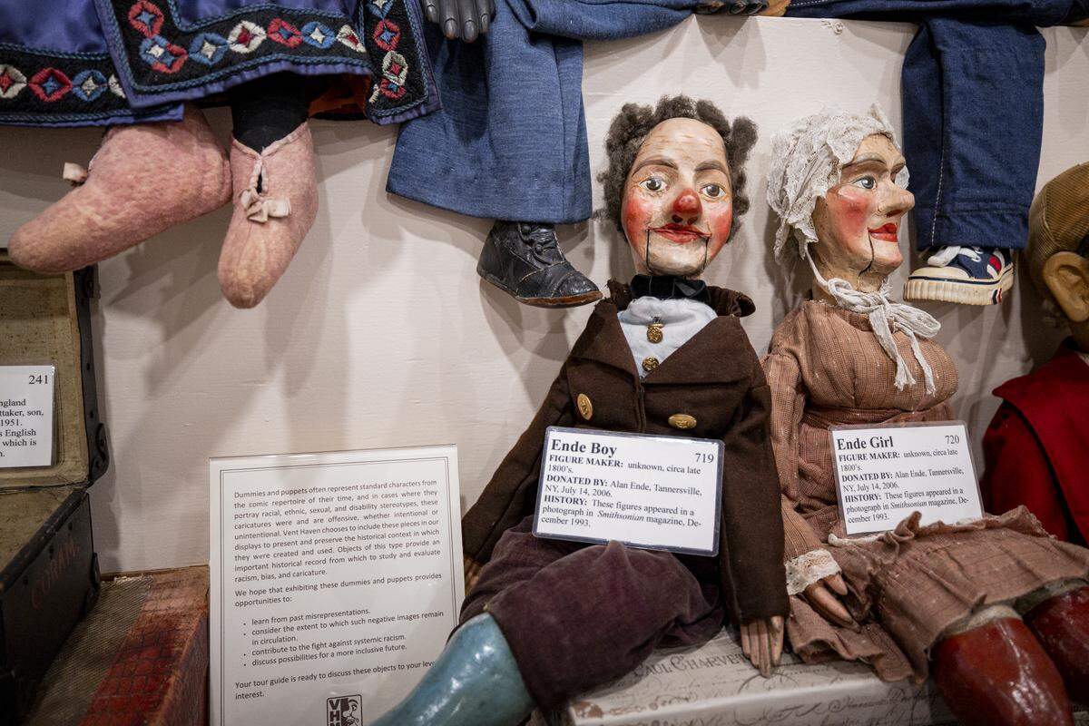 Ventriloquial figures from the vaudevillian era of the art form during a tour on Tuesday, Aug. 12, 2025, at Vent Haven Museum in Fort Mitchell, Ky. A sign also addresses the stereotypes that were common of the vaudevillian era.
