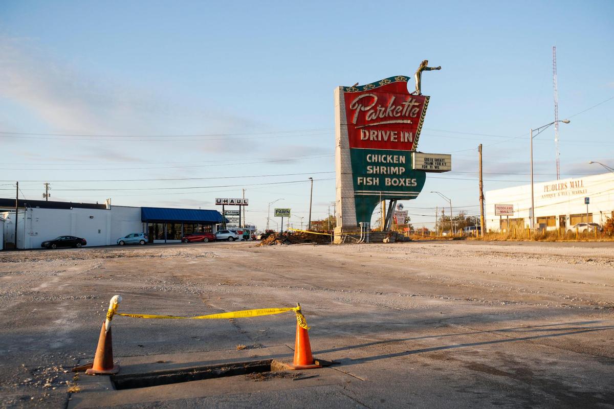 The lot where Parkette Drive in once stood now sits empty except for the sign in Lexington, Ky., Thursday, October 20, 2022. The site will now become part of the neighboring Lexus dealership but the iconic sign will be restored.