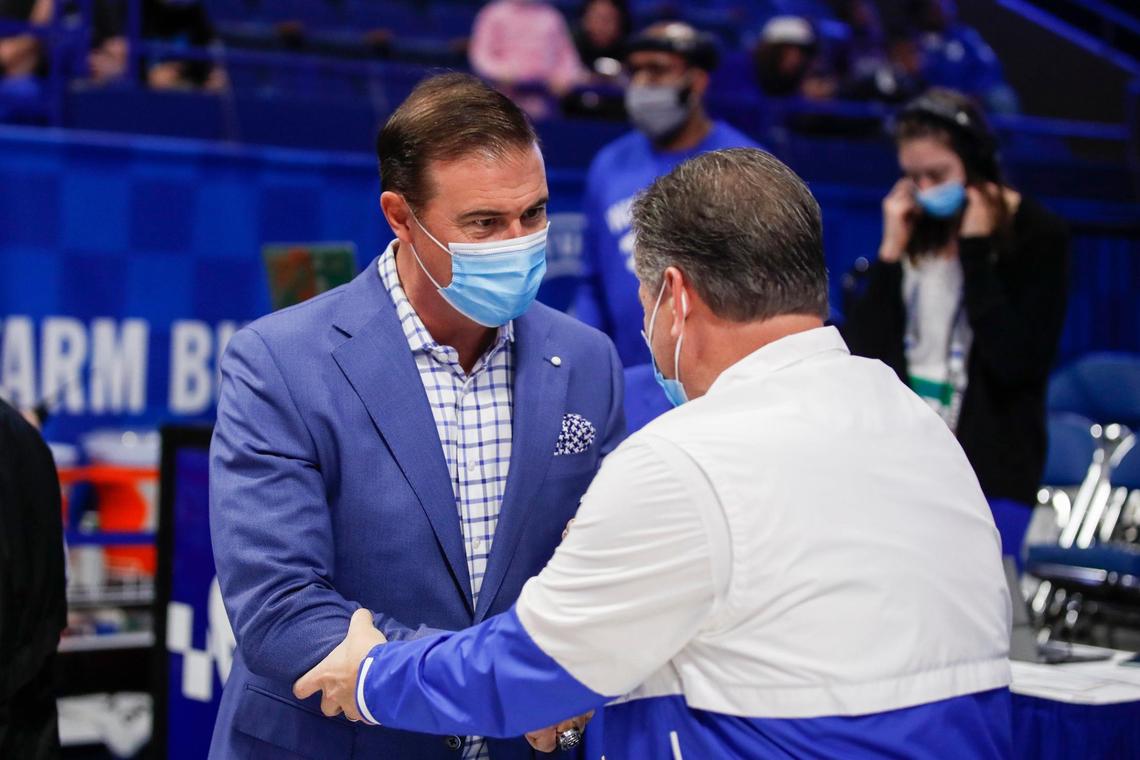 Kentucky men’s basketball coach John Calipari shakes hands with former UK women’s coach Matthew Mitchell before Thursday night’s game.