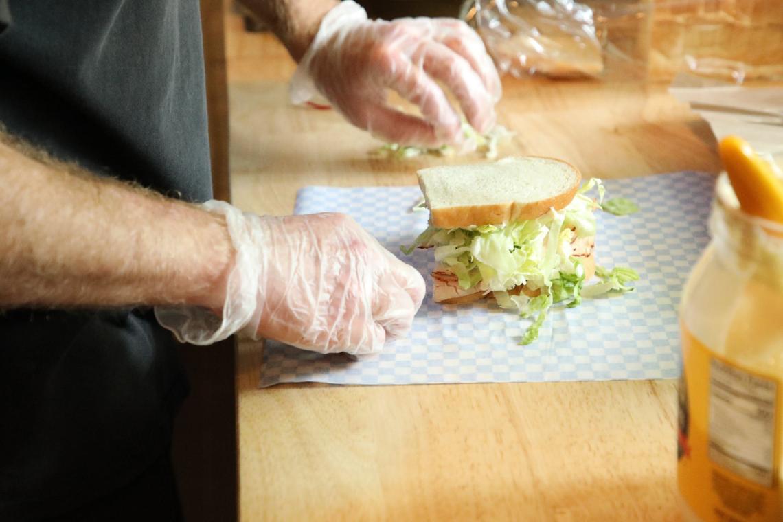 Matt Bastin adding the finishing touches to a hand-crafted sandwich at Wilson’s Grocery on May 23, 2024, in Lexington, Ky.