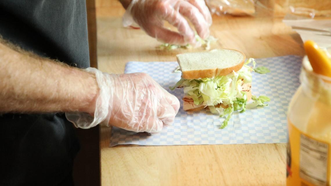 Matt Bastin adding the finishing touches to a hand-crafted sandwich at Wilson’s Grocery on May 23, 2024, in Lexington, Ky.
