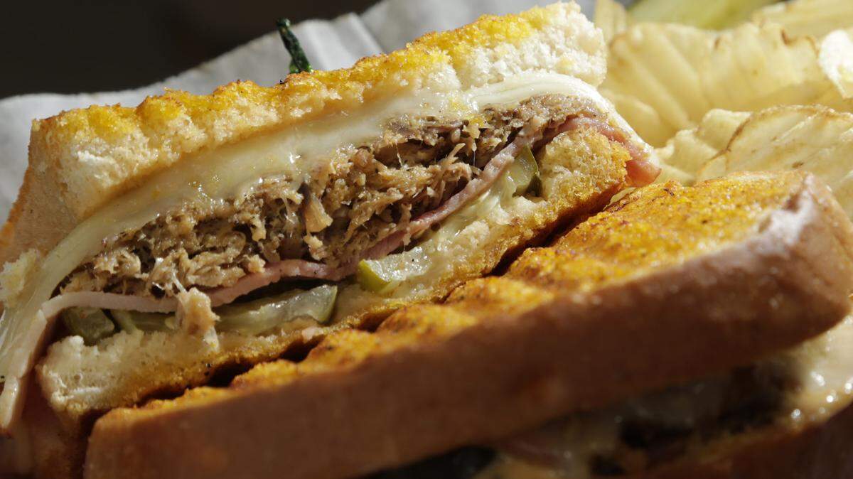 A Cubano sandwich prepared with a side of chips at Wallace Station in  Midway, Ky., on Sept. 10, 2014. Photo by Pablo Alcala | Staff
