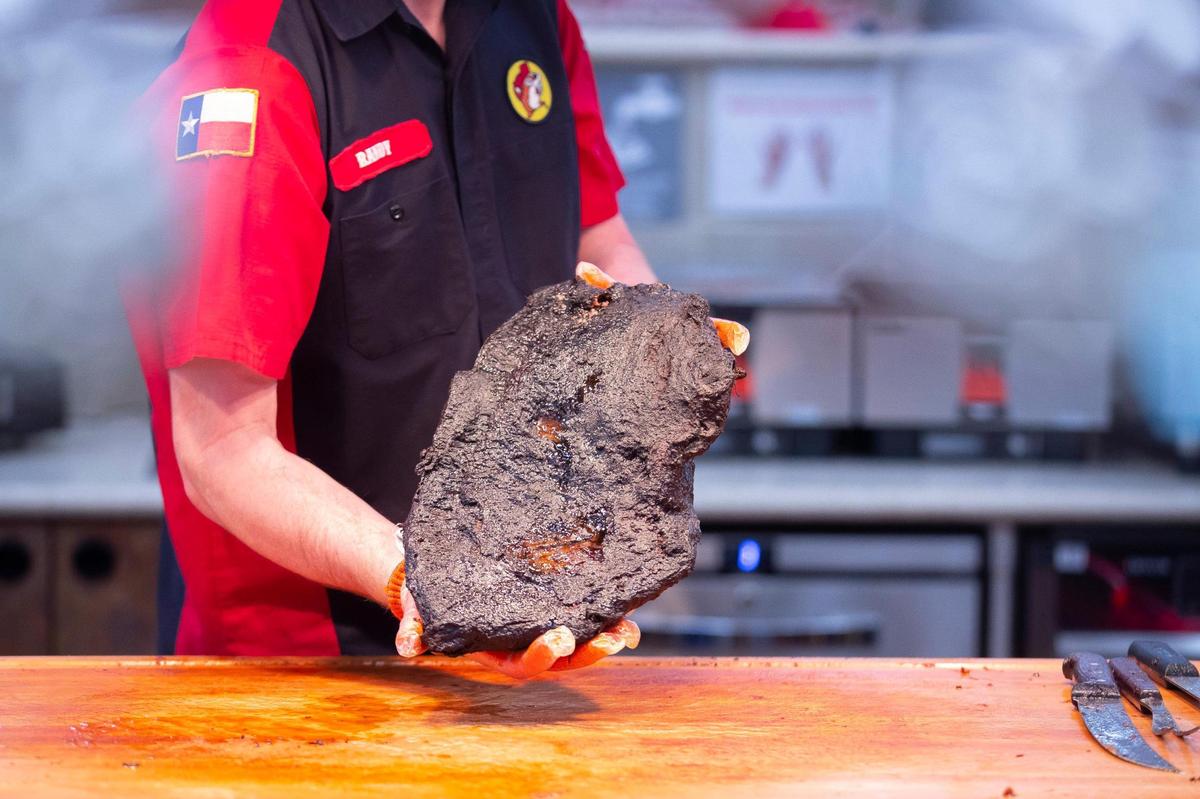 Randy Pauly, Buc-ee’s director of barbecue, holds up a slab of brisket at the company’s new travel center in Richmond, Ky., on Friday, April 15, 2022. 
