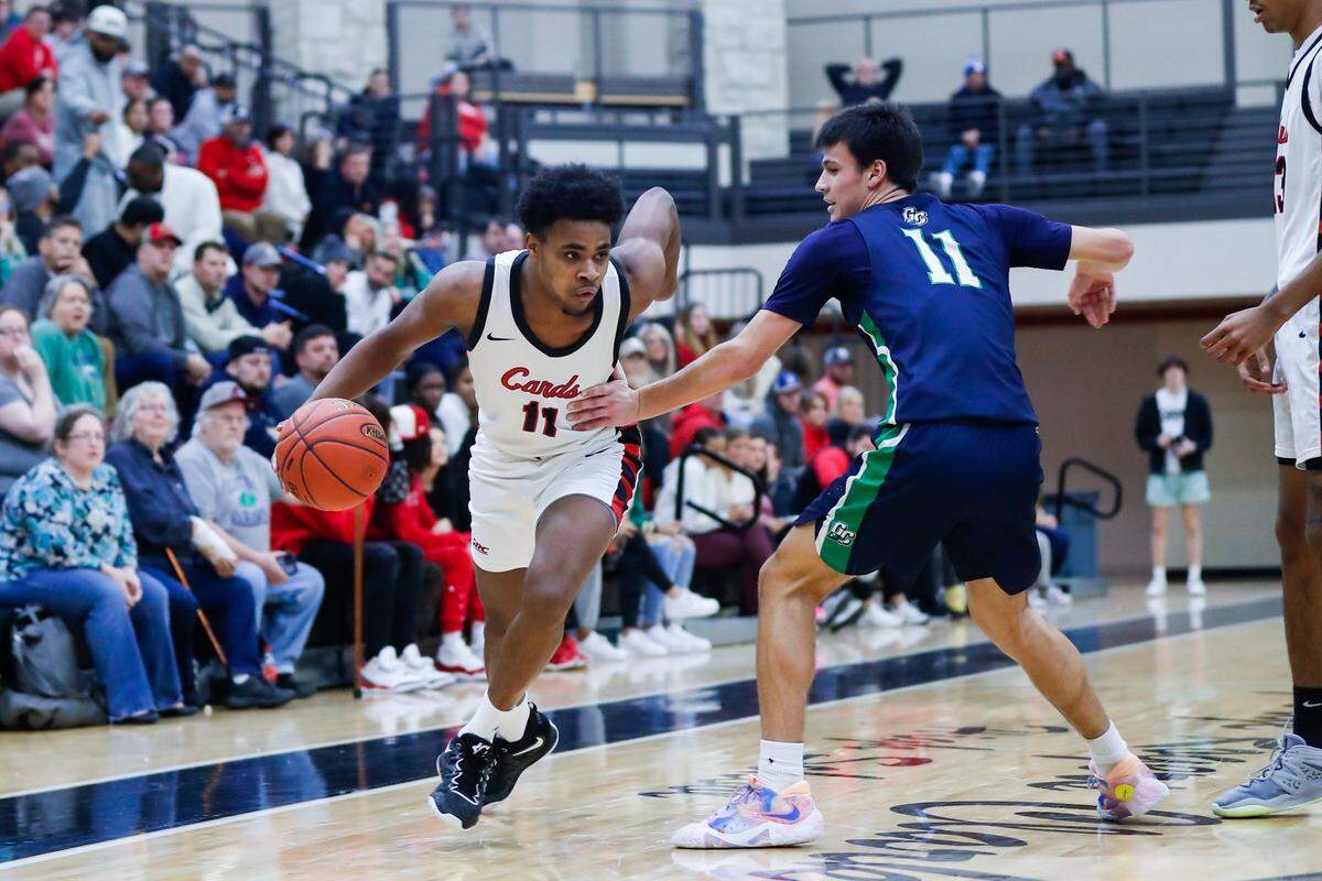 George Rogers Clark guard Jerone Morton (11) dribbles around Great Crossing guard Gage Richardson (11) during a game in Winchester on Jan. 5, 2023.