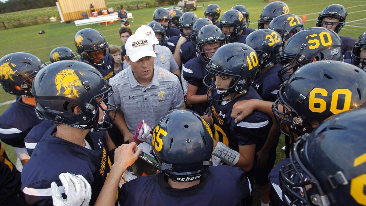 “I’m gonna mess up, our staff will, our kids will, and it’s OK. We’re all learning together,” said Sayre Coach Chad Pennington, left center. “One thing you find about football is even if you’re moving in the wrong direction, if everybody’s moving in the wrong direction together something good normally happens, so that’s what we always talk about.”