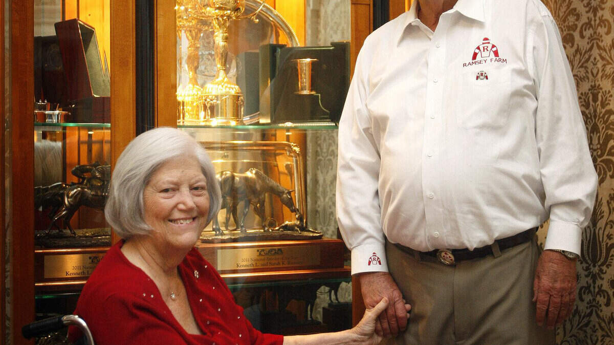 Ken and Sarah Ramsey posed in front of their trophy case last October at their home on Ramsey Farm in Nicholasville.