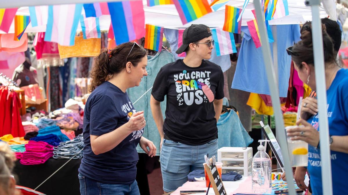 Cara Ellis, left, and Sarah Ratliff talk to festival goers at Pikeville Pride’s booth at the Hillbilly Days Festival in Pikeville last April.
