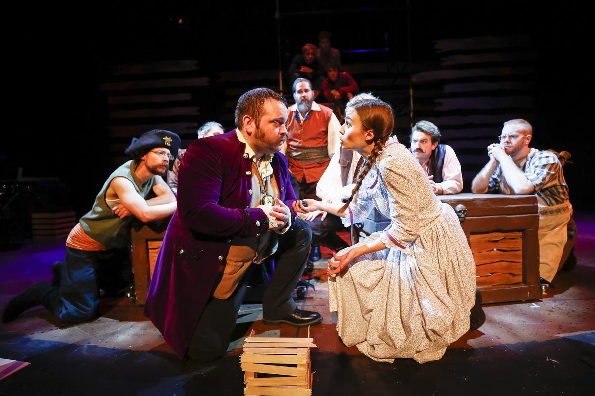James Holeman playing the role of Lord Aster, center left, works through a scene with Kelsey Waltermire playing the role of Molly Aster, center right, during rehearsal for Peter and the Starcatcher at the Woodford Theatre in Versailles.