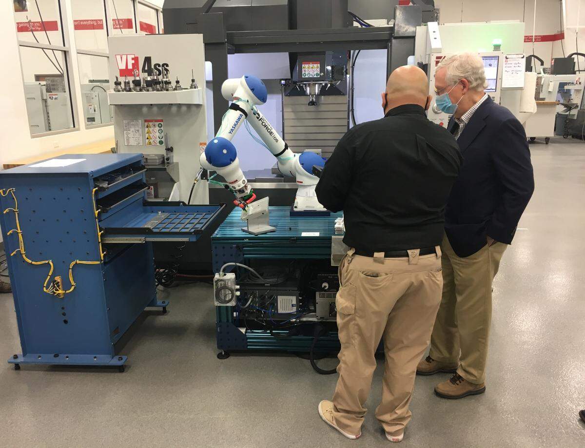 Mike Cepeda, the lead adults instructor at eKAMI, demonstrates to Sen. Mitch McConnell their robot. The institute started a robotics course recently.