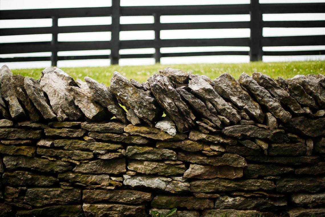 A rock fence runs along Old Frankfort Pike near Three Chimneys Farm in Versailles.