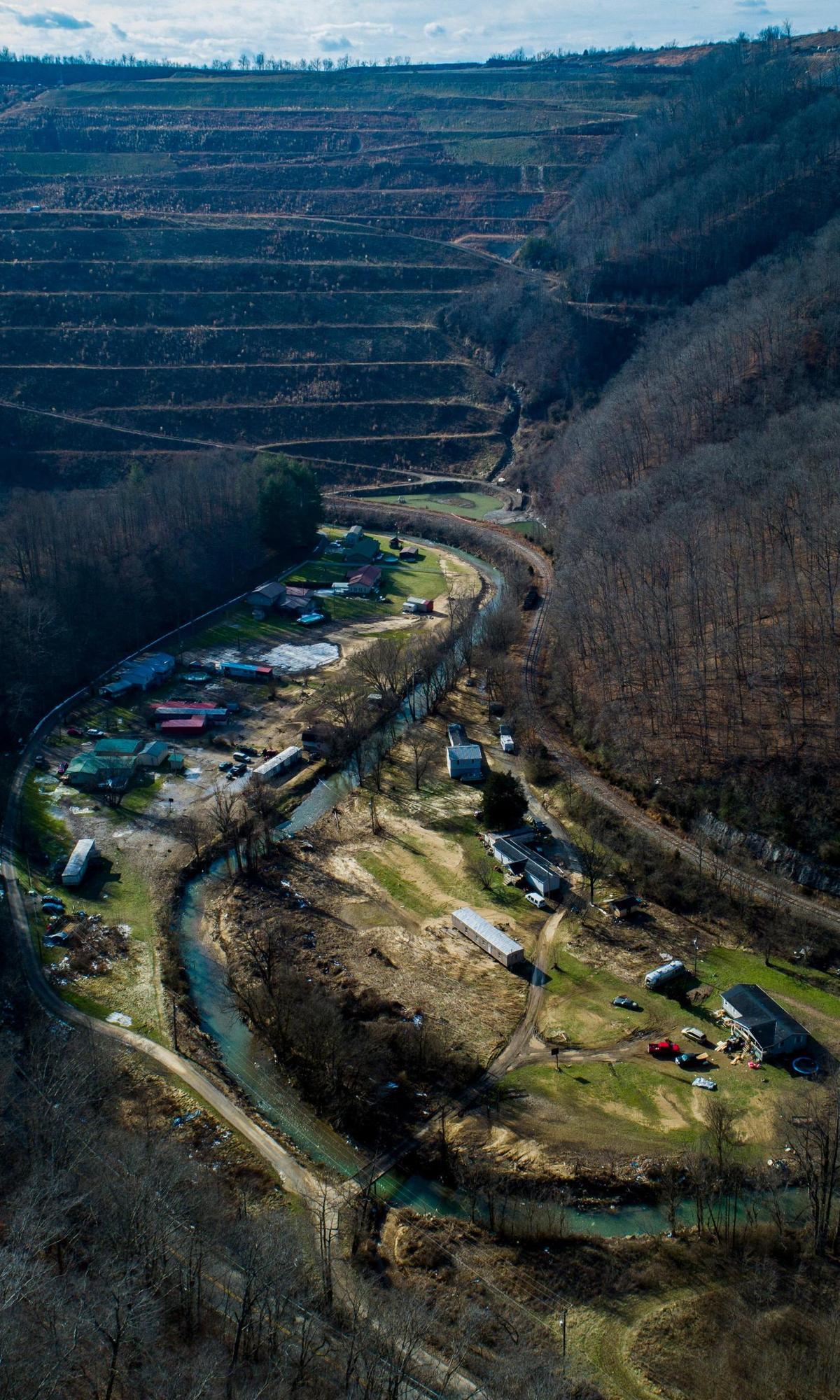 Homes along Smith Bottom Loop stand after Big Creek crested its banks and flooded the neighborhood earlier this month in Sidney, Ky., Thursday, Jan. 13, 2022. Big Creek rose nearly 30 feet in minutes on Jan. 1 causing damages to houses, trailers and vehicles in the valley.