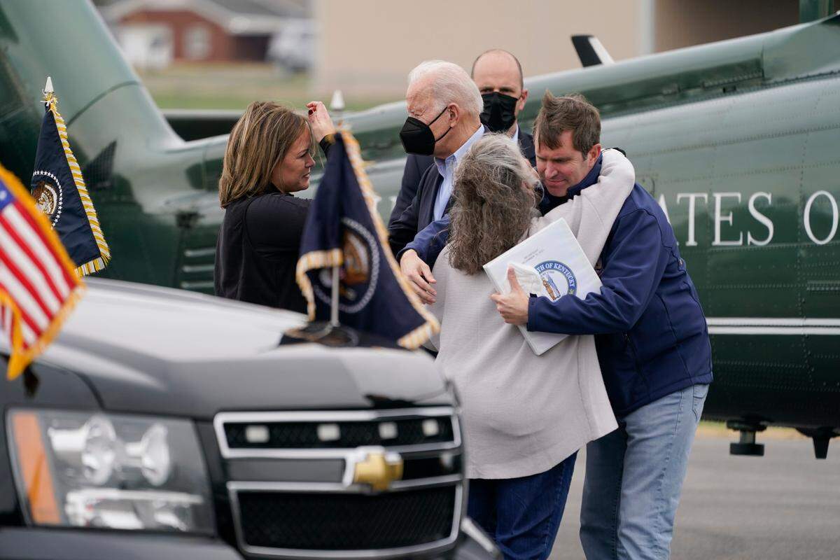 President Joe Biden is greeted by Kentucky Lt. Gov. Jacqueline Coleman, left, Kentucky Gov. Andy Beshear, right, and Mayfield Mayor Kathy Stewart O’Nan as he arrives at Mayfield Graves County Airport to survey storm damage from tornadoes and extreme weather in Mayfield, Ky., Wednesday, Dec. 15, 2021. (AP Photo/Andrew Harnik)