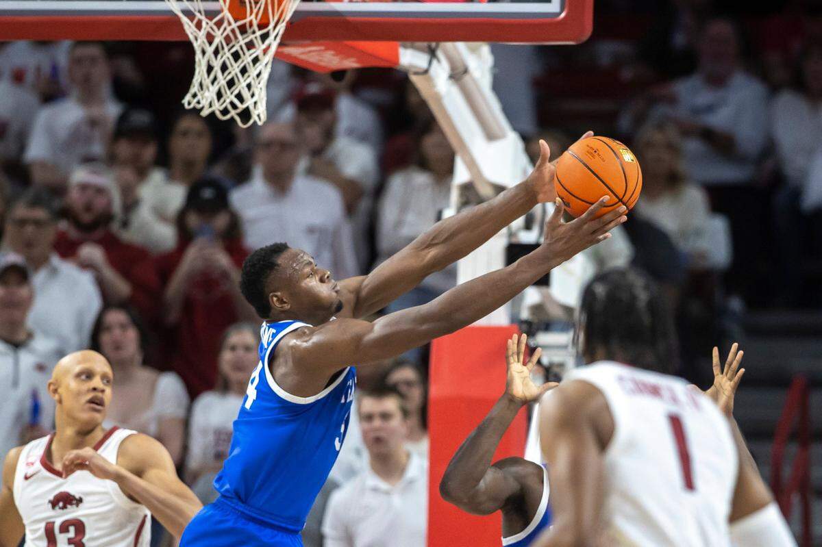 Kentucky forward Oscar Tshiebwe (34) rebounds the ball during Saturday’s game against Arkansas at Bud Walton Arena in Fayetteville, Ark.
