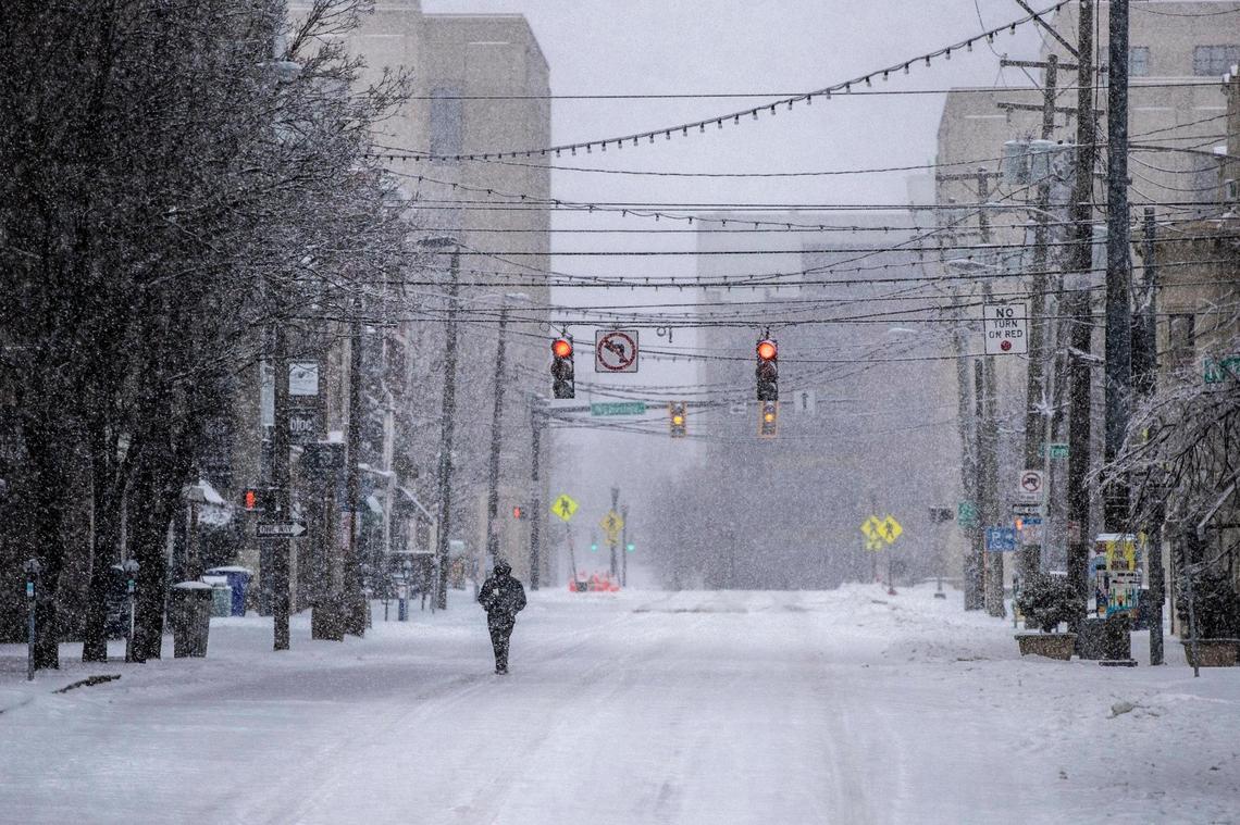 A person walked along snow-covered Short Street in downtown Lexington Tuesday.