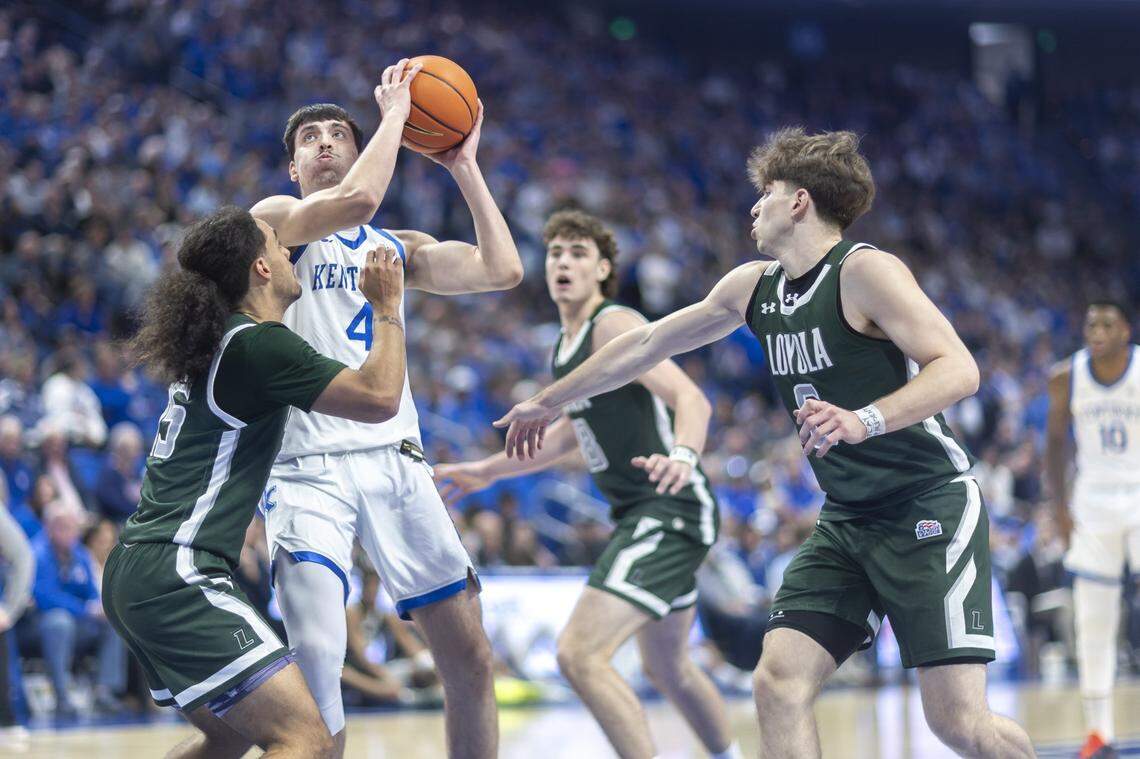 Kentucky forward Andrija Jelavic (4) looks to shoot the ball as Loyola (Maryland) guard Tyson Commander (15) defends during Friday’s game at Rupp Arena.
