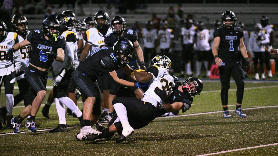 Lexington Catholic’s Ben Schlarman (44) and Jack White (9) tackle Central’s Brian Marshall for a loss in Lexington Catholic's 27-14 win over Louisville Central in the second round of the 3A Kentucky HS Football playoffs Oct. 14.