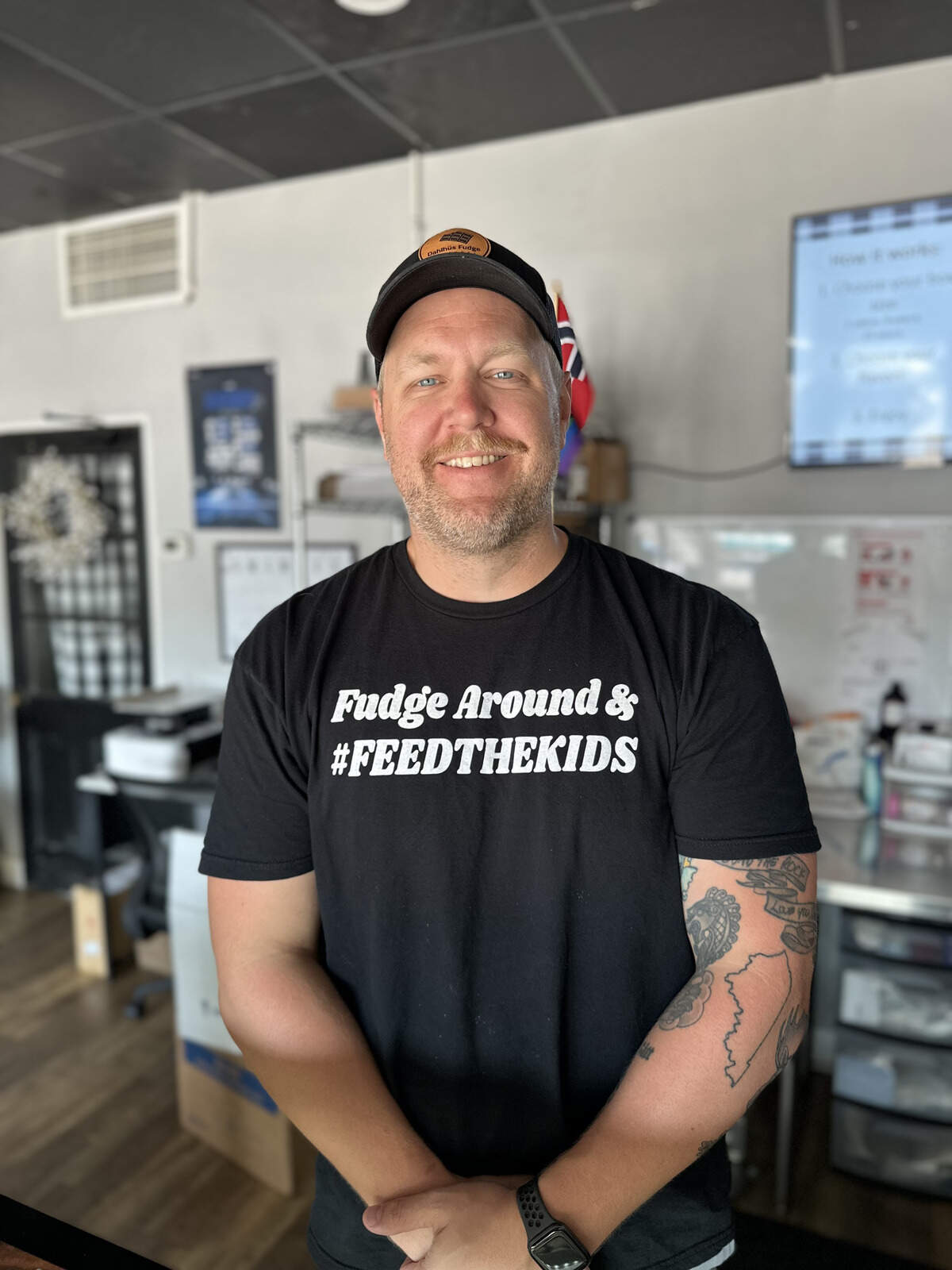 Adam Dahl poses in his shop, located at 219 Woodland Avenue.