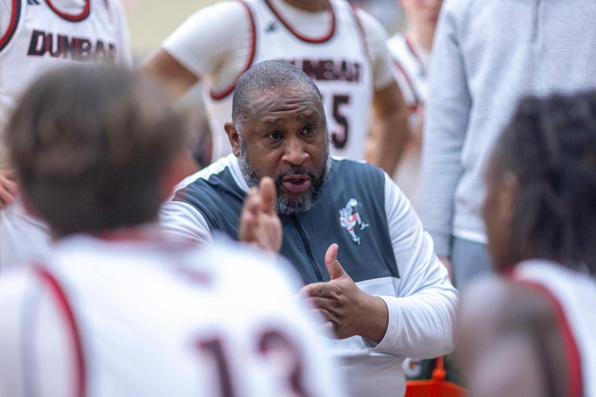 Paul Laurence Dunbar head coach George Baker talks to his players during a timeout in their game against Tates Creek at Paul Laurence Dunbar High School on Thursday.