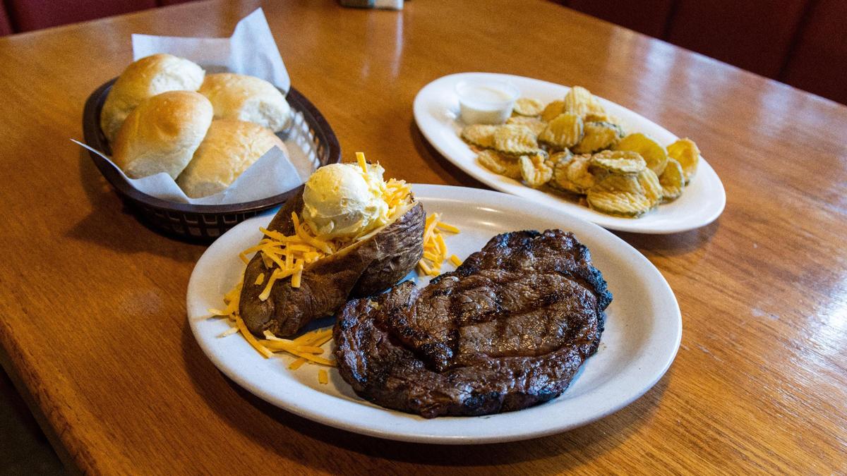 A Steak entree with loaded baked potato, bread and fried pickles from Smokehouse Grill and Buffet in Berea, March 29, 2022.